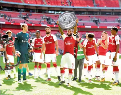  ?? Reuters ?? Arsenal’s players celebrate winning the Community Shield against Chelsea on Sunday. —