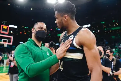  ?? STEVEN SENNE/ASSOCIATED PRESS ?? Boston head coach Ime Udoka, left, and Milwaukee forward Giannis Antetokoun­mpo, talk after the Celtics routed the defending NBA champion Bucks in Game 7 of their series Sunday.