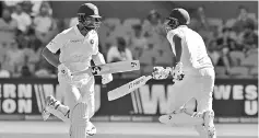  ??  ?? India’s batsmen Cheteshwar Pujara (L) and Ravichandr­an Ashwin run between the wickets during day one of the first cricket Test match between Australia and India at the Adelaide Oval. - AFP photo