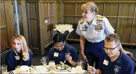  ?? THE BLADE/LORI KING ?? Coast Guard Rear Adm. June Ryan chats before a luncheon with Maritime Academy students Savannah Becker (left), Heaven Abernathy and Jameson Miller in 2016. Ryan is retiring after 33 years in the Coast Guard.