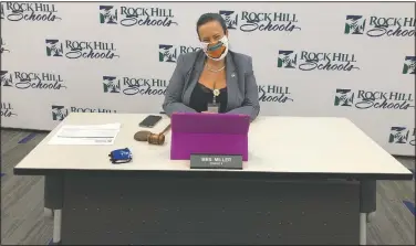  ?? (AP/Jeffrey Collins) ?? Rock Hill School Board Chairwoman Helena Miller sits at her socially distanced table in the district’s meeting room in Rock Hill, S.C., on Monday. Like school boards across the nation, Rock Hill’s board has had to answer the question when do children return to school with no easy or guaranteed safe answer.