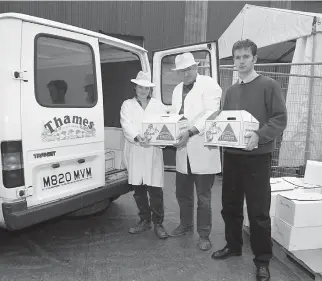  ?? ?? Advertiser staff members helped Tom Copas (centre) load up a van full of turkeys as part of the Cracker Appeal in 1996. Ref:134106-10