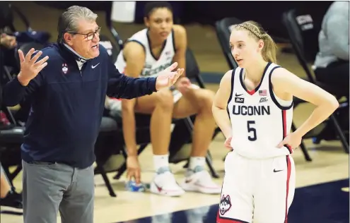  ?? David Butler II / USA TODAY ?? UConn coach Geno Auriemma talks with freshman Paige Bueckers duirng a March game against Marquette. Bueckers averages a team-high 35.8 minutes per game, and getting to leave the court can often be a challenge for Auriemma.