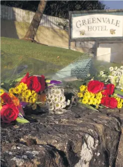  ?? LIAM MCBURNEY ?? Tributes: Flowers placed outside the Greenvale Hotel yesterday to mark the second anniversar­y of the tragic incident