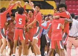  ?? BALTIMORE SUN MEDIA BRIAN KRISTA/ ?? Edmondson players and coaches celebrate after beating Lake Clifton, 56-48, in the Class 1A state final on Saturday at University of Maryland’s Xfinity Center in College Park.