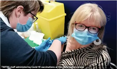  ??  ?? TWFRS staff administer­ing Covid-19 vaccinatio­ns at the Vertu Motors Arena