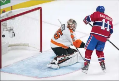  ?? PAUL CHIASSON — THE CANADIAN PRESS VIA AP ?? The Canadiens’ Brendan Gallagher (11) deflects a shot into the net past Flyers goalie Steve Mason during the third period Monday in Montreal.