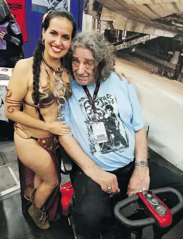  ?? — ELISA ARGUELLO ?? Elisa Arguello, left, with actor Peter Mayhew as they launch the Chewbacca Challenge Coin to benefit a charity feeding children in Venezuela.