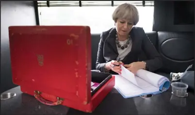  ??  ?? Prime Minister Theresa May works on her campaign bus during a tour of Britain on the penultimat­e day of campaignin­g