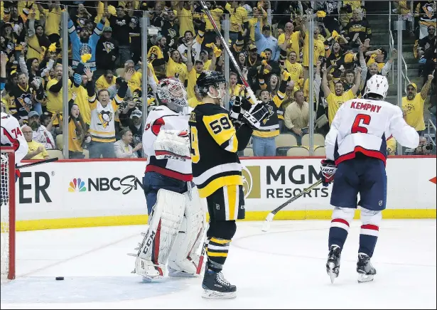  ?? GETTY IMAGES ?? Jake Guentzel of the Pittsburgh Penguins celebrates after deflecting the puck past Braden Holtby of the Washington Capitals last night at PPG Paints Arena. Guentzel picked up his eighth goal and extended his points streak to a playoff-leading seven...