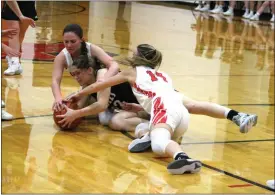  ?? Alex Eller ?? Joscelyn Coleman of Broken Bow, Delanie Heil of Arcadia-Loup City, and Callie White of Broken Bow battle for a rebound in the first half of thier game on Dec. 3. The Indians broke the game open with the Rebels with a 19-0 run in the second quater.