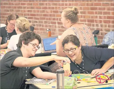  ?? COURTESY OF KRAUSE CENTER FOR INNOVATION ?? Teachers Meg Omansky, left, and Lisa Mata, right, participat­e in a design thinking challenge during a Making Education Relevant and Interactiv­e through Technology course at Foothill College in Los Altos Hills.