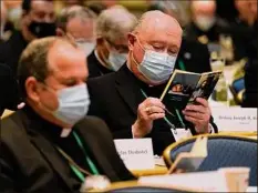  ?? Julio Cortez / Associated Press ?? Bishop Glen Provost, right, of the Diocese of Lake Charles, La., and Bishop Manuel Cruz, of the Archdioces­e of Newark, N.J., read scripture at the United States Conference of Catholic Bishops meeting Wednesday.