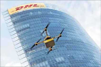  ?? Photo: Wolfgang Rattay/Reuters ?? High flyer: A prototype ‘parcelcopt­er’ is tested by Deutsche Post DHL. Possibilit­ies for the commercial use of drones include security, inspecting buildings, surveying and the film industry.