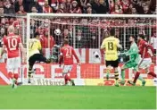  ?? PIC/AP/PTI ?? Dortmund’s Pierre-emerick Aubameyang scores his side’s second goal during the German Soccer Cup semi-final match between FC Bayern Munich and Borussia Dortmund at the Allianz Arena