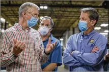  ?? ALYSSA POINTER / ALYSSA.POINTER@AJC.COM ?? Architectu­ral Brass Company Managing Director of Sales Richard Stinson (left) speaks with Gov. Brian Kemp (right) on a tour of the facility in Bankhead. The company has received funding through the Paycheck Protection Program.