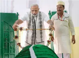  ?? — PTI ?? Prime Minister Narendra Modi offers chadar at Sant Kabir’s mazaar at Maghar in Sant Kabir Nagar district of Uttar Pradesh on Thursday.