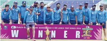  ?? — AFP ?? Sri Lanka players pose with the series trophy after winning the second and last Test against Bangladesh in Chittagong.