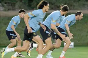  ?? — AFP ?? Uruguay’s defender Diego Godin (R) takes part in a training session at Al Erssal in Doha.