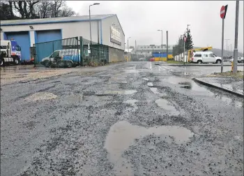  ??  ?? 01_B05pot01 Welcome to Arran: potholes are the first thing drivers arriving at the Brodick ferry terminal see as they turn into Market Road.