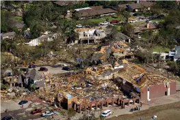  ?? Associated Press ?? ■ Damage to Primera Iglesia Bautista Mexicana church, bottom, on Walnut Hill and homes behind it is seen in an aerial view of tornado damage Monday in Dallas.