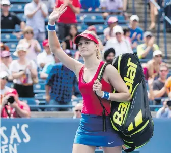  ?? MARK BLINCH, THE CANADIAN PRESS ?? Canadian Eugenie Bouchard salutes the crowd as she leaves the court after being defeated by Donna Vekic of Croatia during their first-round match in Toronto.