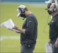  ?? LYNNE SLADKY — THE ASSOCIATED PRESS ?? New York Jets head coach Adam Gase looks at copies of plays during the first half of Sunday’s game.