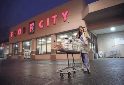  ??  ?? Groceries such as Food City in Harlan reserved a one hour 7 a.m. shopping period for seniors. Ann Reid, 70, a retired medical worker, pushed a cart of bottled water and food. “I'm really scared,” she said.