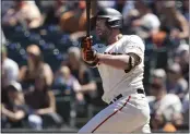  ?? DARREN YAMASHITA — THE ASSOCIATED PRESS ?? The San Francisco Giants’ Darin Ruf watches his RBI single against the Cincinnati Reds during the seventh inning Sunday in San Francisco.