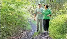  ?? STAFF FILE PHOTO ?? Patrick Dean, recreation­al trails program coordinato­r, and Janice Thomas, president of the Mountain Goat Alliance Board, walk along an old rail bed at the intersecti­on of Industrial Park Road and Parton Farm Road in Tracy City in 2013.