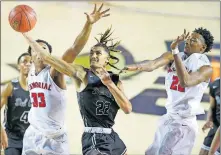  ?? OKLAHOMAN] [BRYAN TERRY, THE ?? Del City's Nathaniel Goodlow goes to the basket between Tulsa Memorial's Julian Cockrell, left, and Kalib Boone during the Class 5A boys championsh­ip game last Saturday. At the same time that game was happening at the Mabee Center in Tulsa, the Class 2A girls final was being played at the Big House in Oklahoma City.