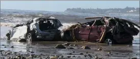  ?? The Associated Press ?? Cars and debris that washed to the coast from storms and flooding are shown on a beach in Montecito, Calif.