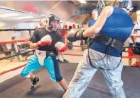  ??  ?? Antonio Martinez, left, spars with Michael Martinez in preparatio­n for a bout later this month.