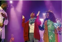  ?? PHOTO: WASHINGTON POST ?? Janqueshia Gay, 27, from Baltimore raises her hands while thanking pastor Stephen Chandler, left, and his wife, Zai Chandler, right, after she won a new car at Destiny Church in Columbia, Maryland.