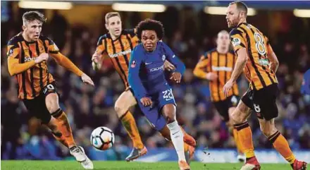  ?? REUTERS PIC ?? Chelsea’s Willian (centre) is surrounded by Hull City players in their FA Cup fifth round tie at Stamford Bridge on Friday.