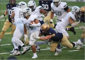  ?? TIM PHILLIS — FOR THE NEWS-HERALD ?? John Carroll defensive end Harrison Richardson of NDCL tackles Marietta running back Bryce Agnew March 26during the Blue Streaks’ 34-10victory at Don Shula Stadium.