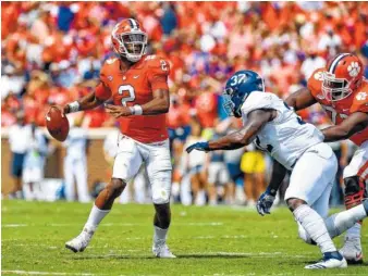  ?? AP FILE PHOTO/RICHARD SHIRO ?? Clemson quarterbac­k Kelly Bryant looks to pass while pressured by Georgia Southern’s Lane Ecton during a game earlier this season in Clemson, S.C. Bryant says he plans to transfer after being demoted.