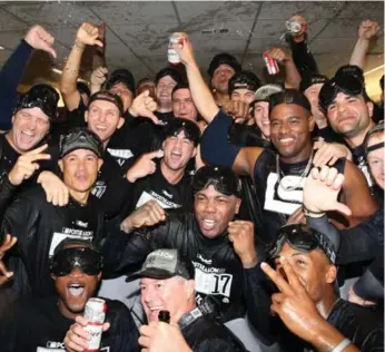  ?? TOM SZCZERBOWS­KI/GETTY IMAGES ?? The New York Yankees celebrate wrapping up at least a wild-card spot after Saturday’s victory over the Blue Jays at the Rogers Centre. They trail the AL East-leading Red Sox by four games.