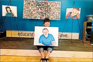  ?? MIKE NOLAN/DAILY SOUTHTOWN ?? Diane Husar, founder of GiGi’s Playhouse in Tinley Park, holds a photo of her son, Luke, inside the facility’s new location. GiGi’s Playhouse assists children and adults with Down syndrome and their families.