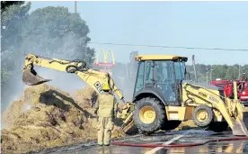  ?? PETE FISHER/POSTMEDIA NETWORK ?? Firefighte­rs battle the tractor-trailer fire on the Highway 401 eastbound lanes of Port Hope on Tuesday morning.