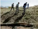  ??  ?? Sappers walk past an unexploded rocket after recent shelling during the military conflict over the breakaway region of Nagorno-karabakh (Reuters)