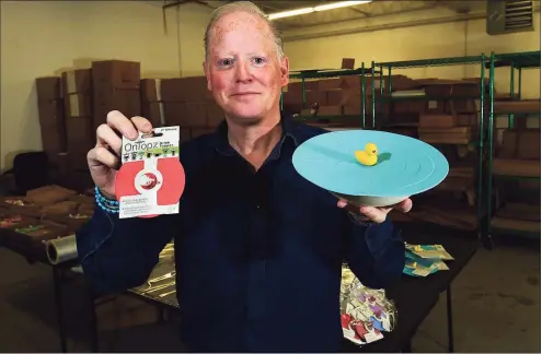  ?? Erik Trautmann / Hearst Connecticu­t Media photos ?? Norwalk resident David Farnworth, CEO and founder of OnTopz, at the company’s facility on Wednesday in Norwalk. OnTopz manufactur­es round silicone lids that seal the the tops of open beverage glasses and food containers topped by whimsical characters.