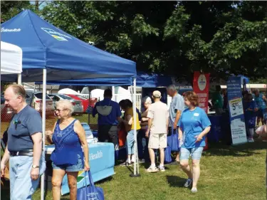  ?? TYLER RIGG — THE NEWS-HERALD ?? Fair-goers check out a variety of vendors on the morning of “Seniors Day” at the Lake County Fair, July 26.