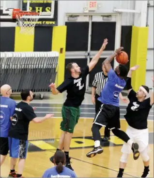  ?? JONATHAN TRESSLER — THE NEWS-HERALD ?? Matt Jackson from the Lake County Sheriff’s Office goes up for a basket as LaMuth Middle School teacher and boys basketball coach Matt Grendel moves to block the shot during the Hoops 4 Hope event March 21 at Riverside High School.