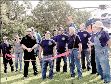  ?? SALLY CARROLL/MCDONALD COUNTY PRESS ?? Grass and dust flew into a crystal blue sky Saturday morning as Mercy pilot Max Timmons successful­ly landed a helicopter ambulance on the new landing pad at White Rock Fire Station No. 2.