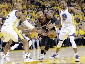  ?? AP/JEFF CHIU ?? Portland guard Damian Lillard (center) loses the ball between Golden State forwards David West (3) and Andre Iguodala (9) in the second half of their NBA Western Conference playoff Sunday in Oakland. The Warriors, behind Kevin Durant’s 32 points, won...