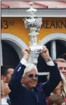  ?? AP/STEVE HELBER ?? Bob Baffert holds the Woodlawn Vase after his horse Justify won with Mike Smith aboard in the 143rd Preakness Stakes at Pimlico Race Course in Baltimore. The victory was Baffert’s seventh Preakness Stakes title and his fifth after a Kentucky Derby victory.