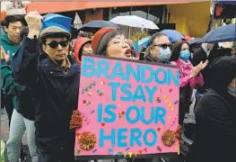  ?? Gary Coronado Los Angeles Times ?? BECKI PANG cheers for Brandon Tsay as he is awarded a medal of courage from the Alhambra Police Department during the city’s Lunar New Year Festival.