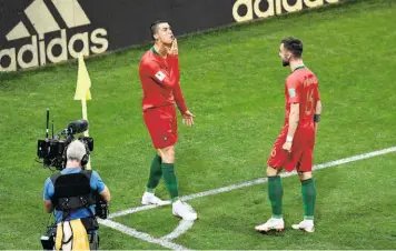  ?? AFP ?? The GOAT: After opening his account against Spain with a penalty kick, Ronaldo, in the course of his celebratio­n, rubbed his chin as teammate Bruno Fernandes looked on. Onlookers believed that Ronaldo was signifying a goat, which, if taken as an acronym, GOAT, expands to the Greatest Of All Time!