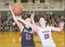  ?? RICK PECK/SPECIAL TO MCDONALD COUNTY PRESS ?? McDonald County’s Kristin Penn battles with Nevada’s Teagan Charles for a rebound during the Lady Mustangs’ 58-22 loss to the Lady Tigers on Feb. 8 at Nevada High School.